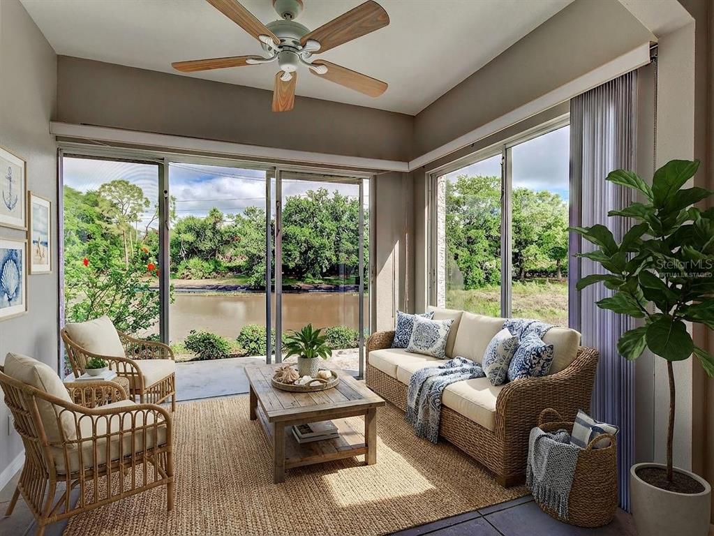 902 Addington Court, Unit 103 Venice, FL 34293 - Photo 10 of 48 a living room with furniture and a potted plant