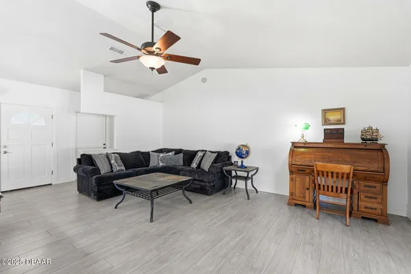 a living room with furniture and a wooden floor