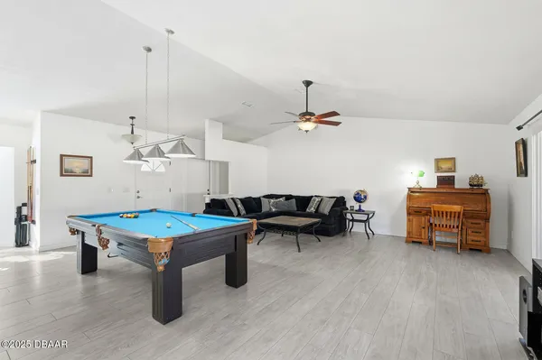 a room with furniture and pool table