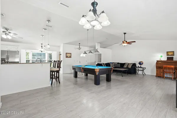 a living room with lots of furniture and a chandelier