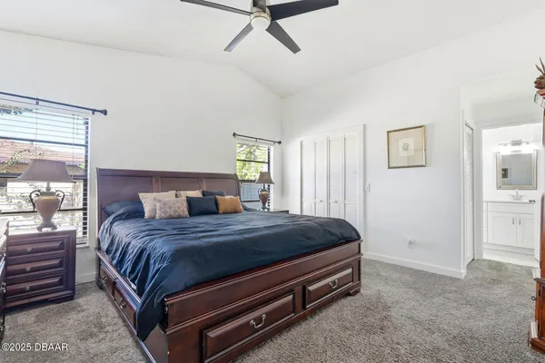 a bed sitting in a bedroom chandelier and a dresser