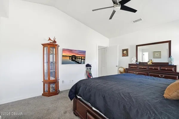 a bed sitting in a bedroom and a chandelier