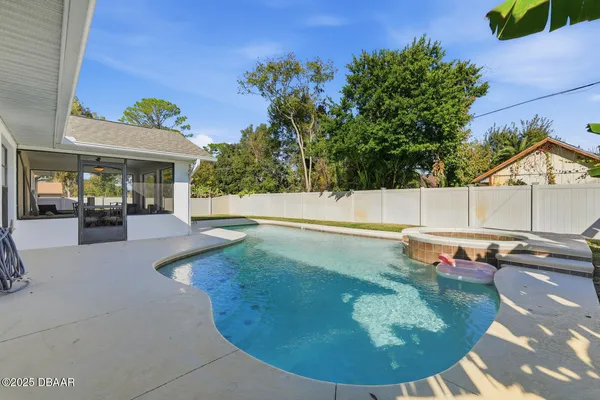 a view of a swimming pool with a sitting in a yard