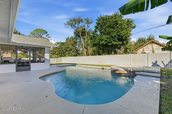 a view of a house with swimming pool and sitting area