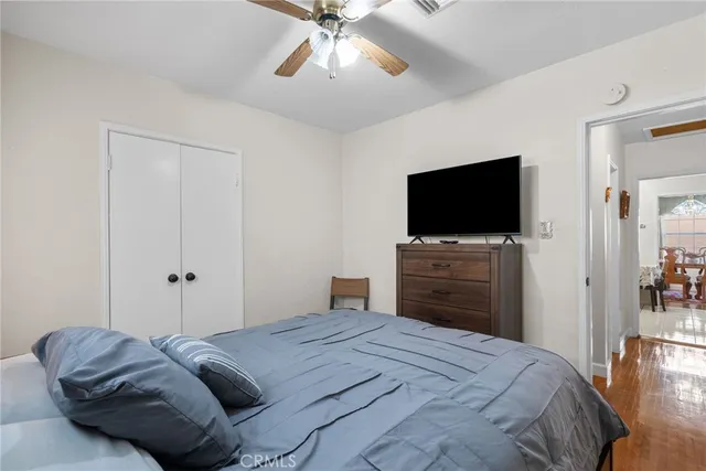 a bedroom with a bed and a flat screen tv