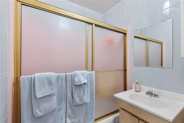 a bathroom with a sink mirror and vanity