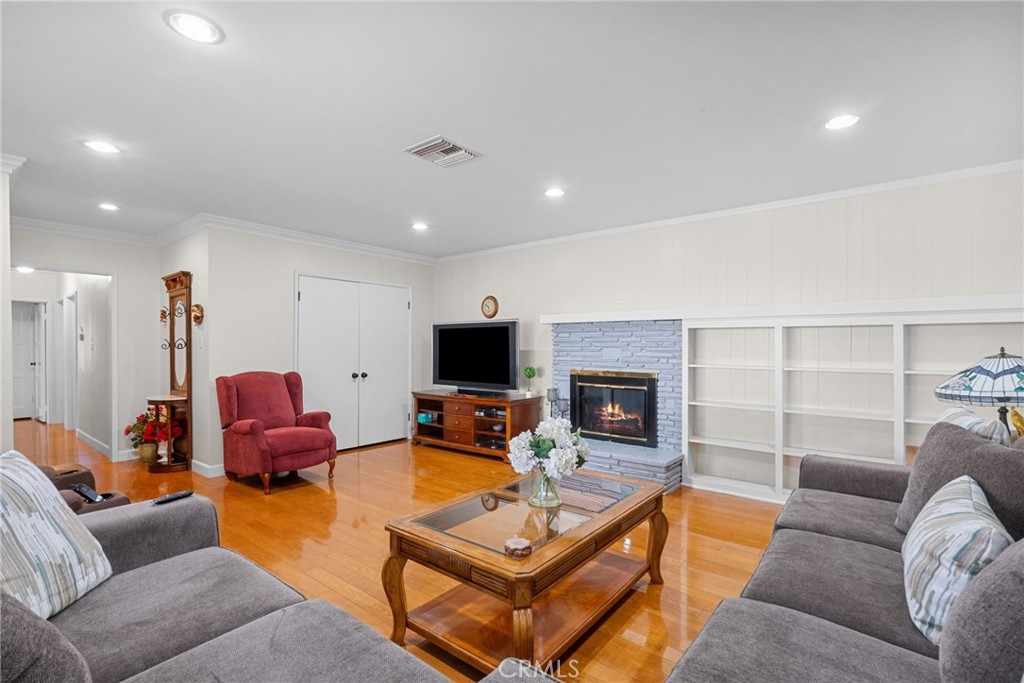 622 Griffith Street San Fernando, CA 91340 - Photo 20 of 35 a living room with furniture a fireplace and a flat screen tv