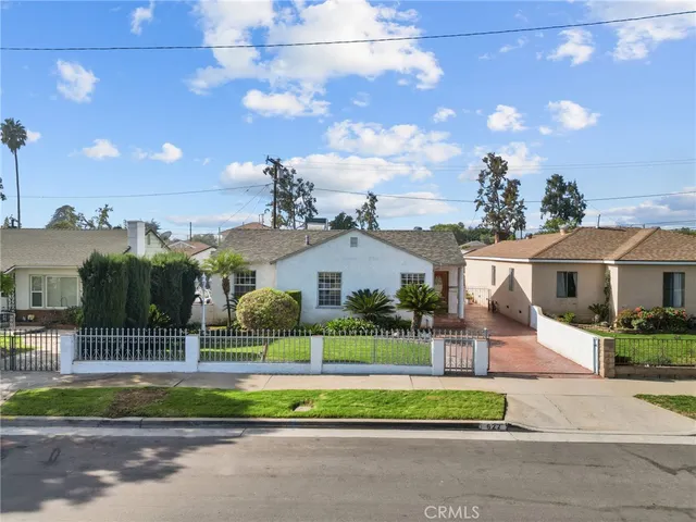 a view of a house next to a yard