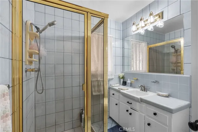 a bathroom with a double vanity sink mirror and shower