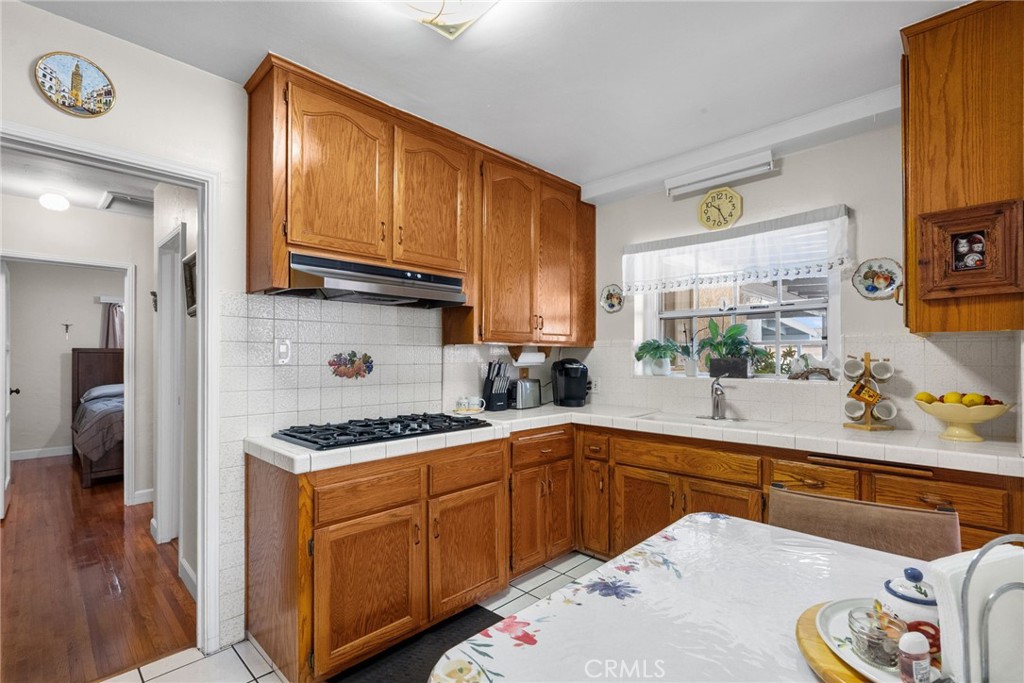 622 Griffith Street San Fernando, CA 91340 - Photo 23 of 35 a kitchen with stainless steel appliances a sink stove and cabinets