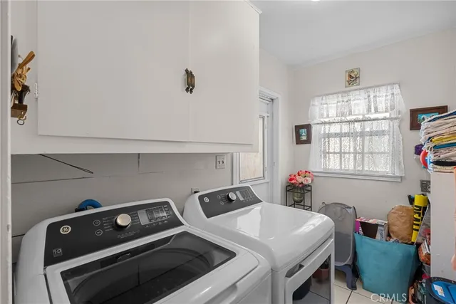 a utility room with dryer washer and a window