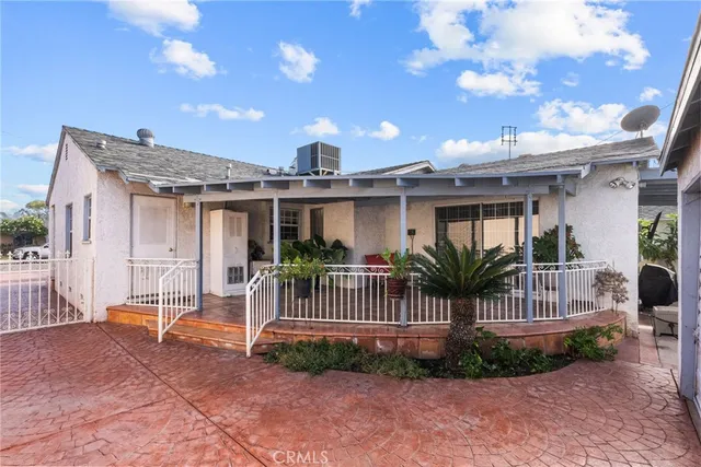an aerial view of a house with yard and patio