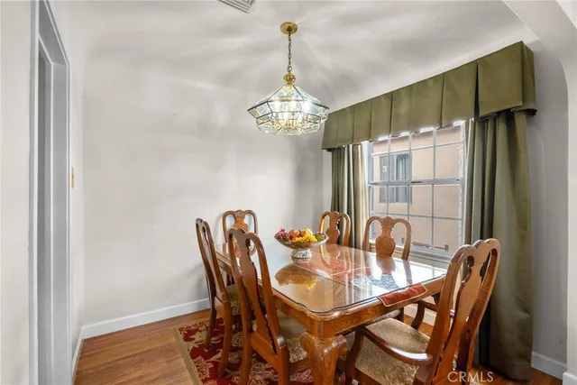a dining room with furniture wooden floor a chandelier