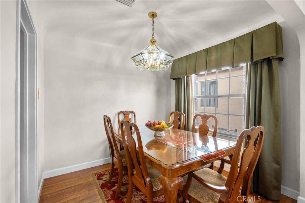 622 Griffith Street San Fernando, CA 91340 - Photo 7 of 35 a dining room with furniture wooden floor a chandelier
