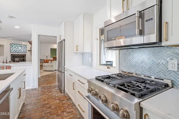 a kitchen with stainless steel appliances granite countertop a stove and a sink