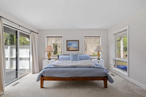 a bedroom with bed and glass window