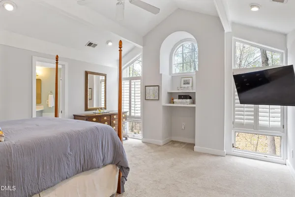 a bedroom with a bed and a large window