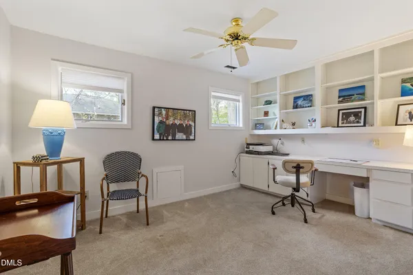 a workspace with a desk chair and painted walls
