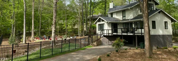 a small yard with fountain in front of it