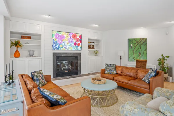 a living room with furniture and a fireplace