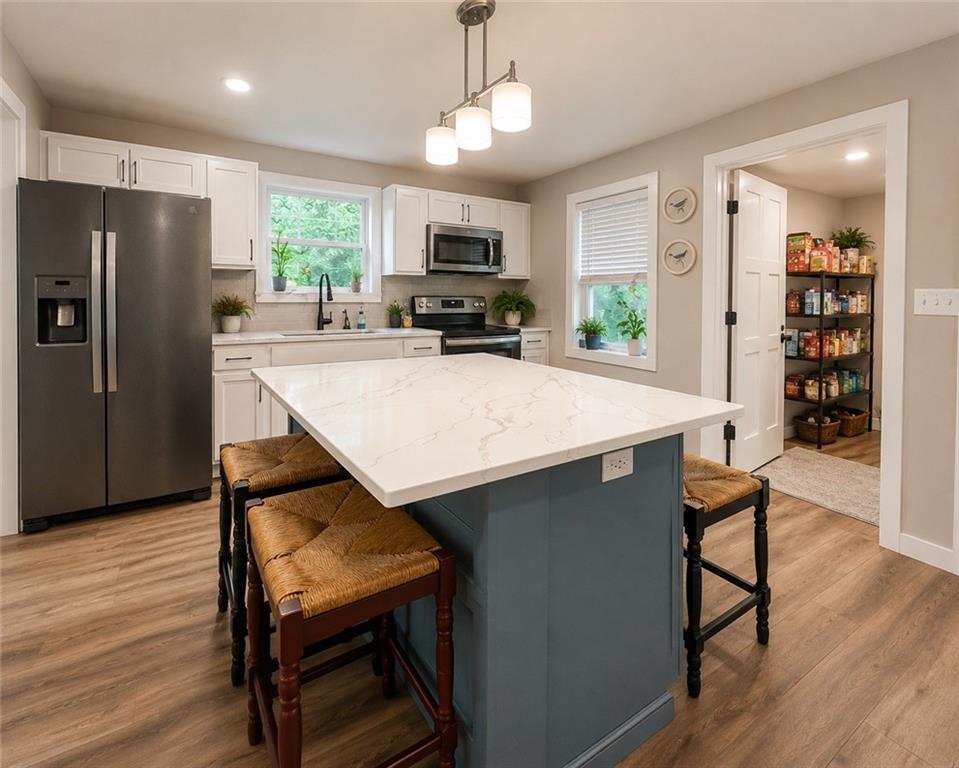 960 South Main Street Jasper, GA 30143 - Photo 2 of 12 a kitchen with a table chairs refrigerator and window