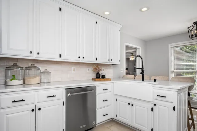 a living room with furniture a fireplace and a chandelier