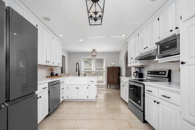 a bedroom with bed and a chandelier