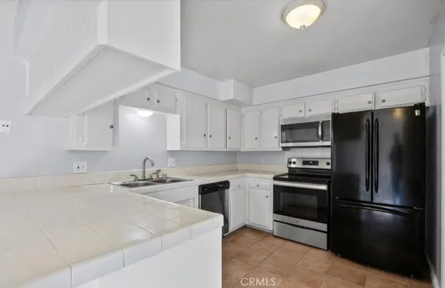 a kitchen with a sink a stove and refrigerator