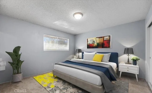 a bedroom with a bed and a potted plant