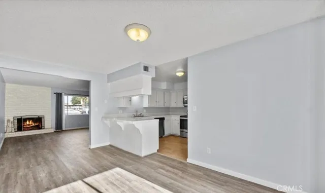 a view of kitchen with cabinets and wooden floor