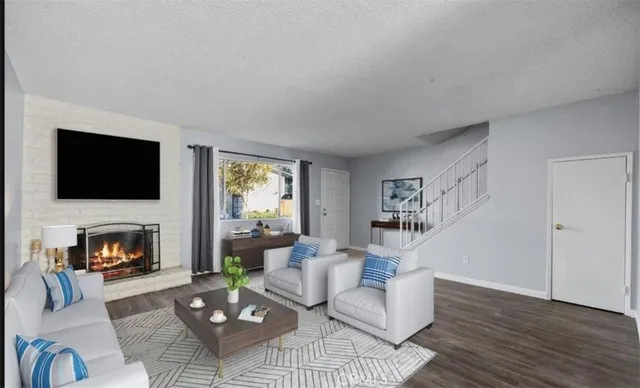 a living room with furniture flat screen tv and a fireplace