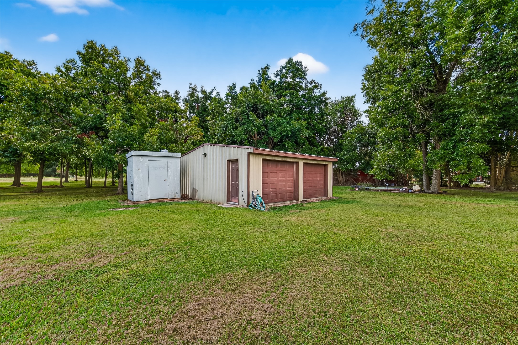 12021 7th 1/2 Street Santa Fe, TX 77510 - Photo 14 of 49 This photo shows a spacious backyard with a 24 x 24 workshop. The area is surrounded by offering a peaceful and private setting.