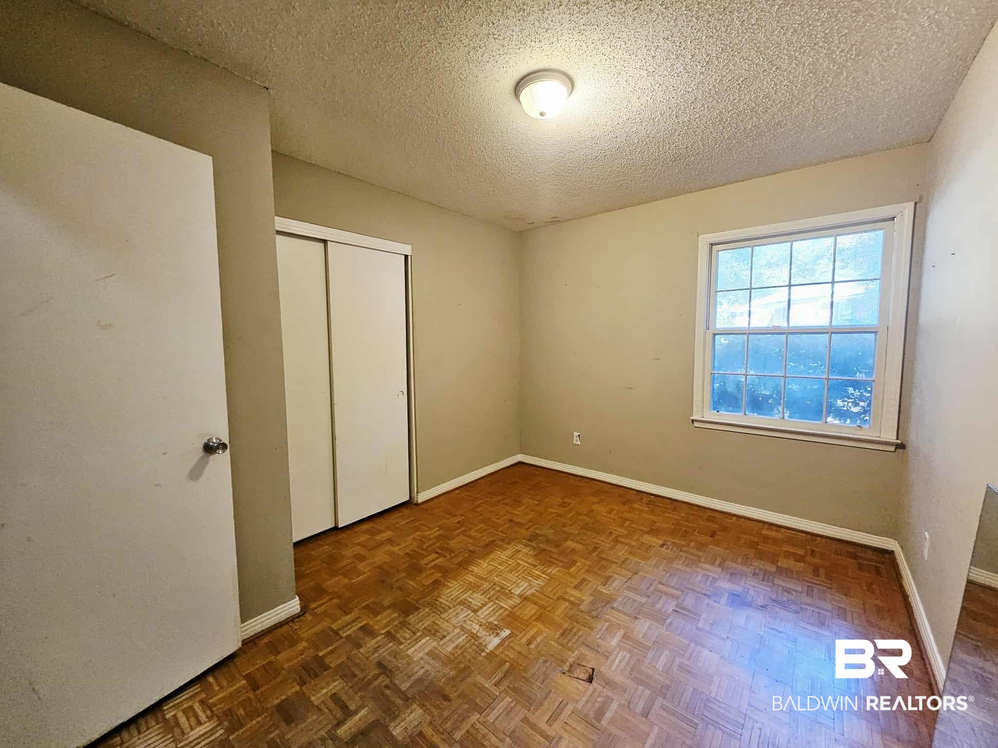 324 Vanderbilt Drive Mobile, AL 36608 - Photo 8 of 17 Unfurnished bedroom with a textured ceiling and a closet