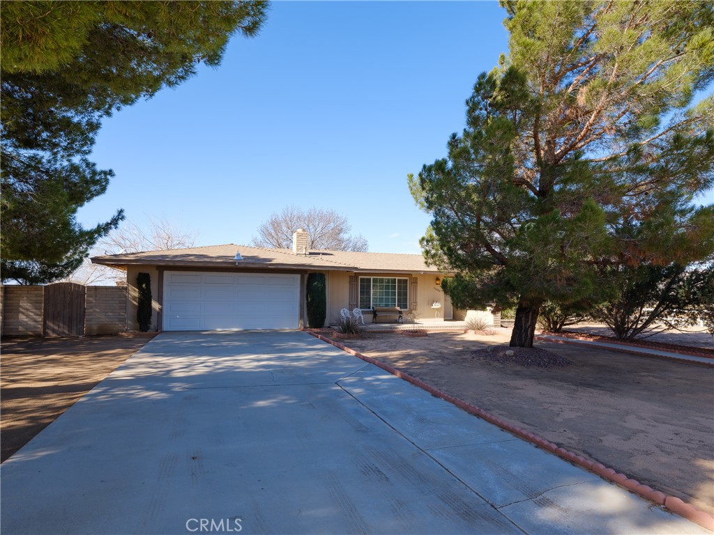 16084 Pawnee Road Apple Valley, CA 92307 - Photo 1 of 1 a view of a house with a yard and garage
