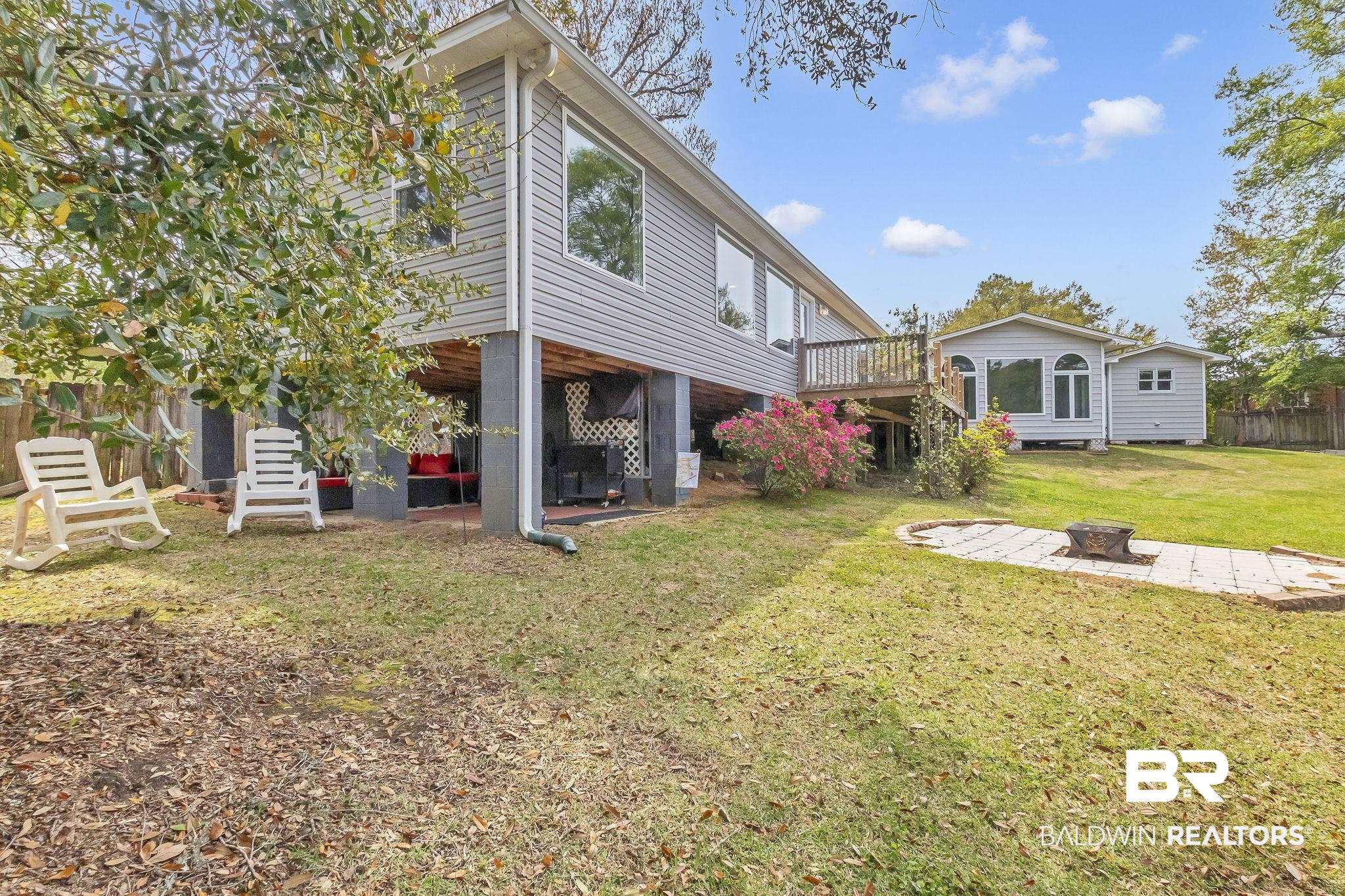 2901 Alston Court Mobile, AL 36605 - Photo 49 of 59 Rear view of property featuring a fire pit, a patio area, a deck, fence, and a yard