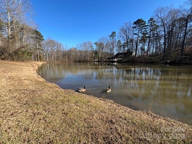 a view of a lake with a house in the background