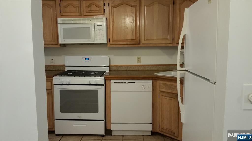 1138 Sycamore Lane Mahwah, NJ 07430 - Photo 4 of 12 a kitchen with a stove and white cabinets