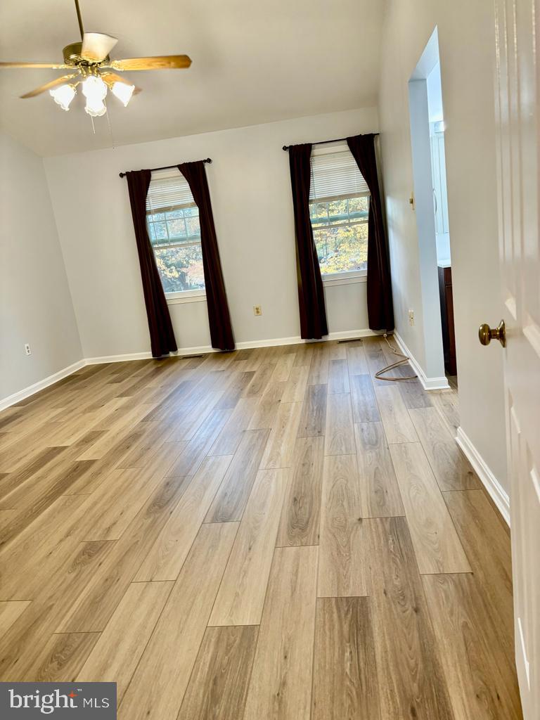 6803 Wild Rose Court Springfield, VA 22152 - Photo 8 of 49 wooden floor in an empty room with a window