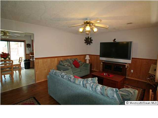 1906 Whitcomb Road Forked River, NJ 08731 - Photo 5 of 10 a living room with furniture and a flat screen tv