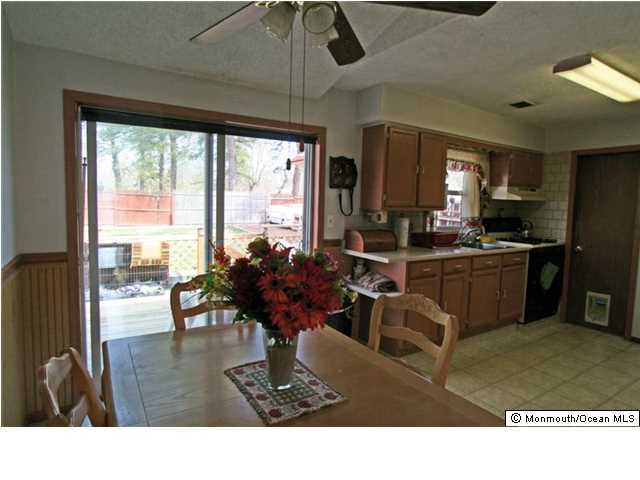 1906 Whitcomb Road Forked River, NJ 08731 - Photo 7 of 10 a living room with stainless steel appliances kitchen island granite countertop furniture a rug and a large window
