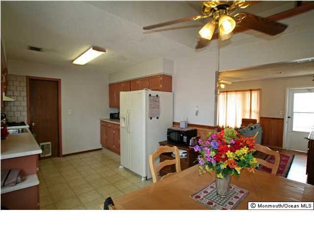 1906 Whitcomb Road Forked River, NJ 08731 - Photo 8 of 10 a room with chandelier fan and a dining table