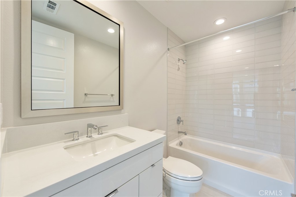 209 Mask Irvine, CA 92618 - Photo 16 of 40 a bathroom with a granite countertop sink a toilet and shower