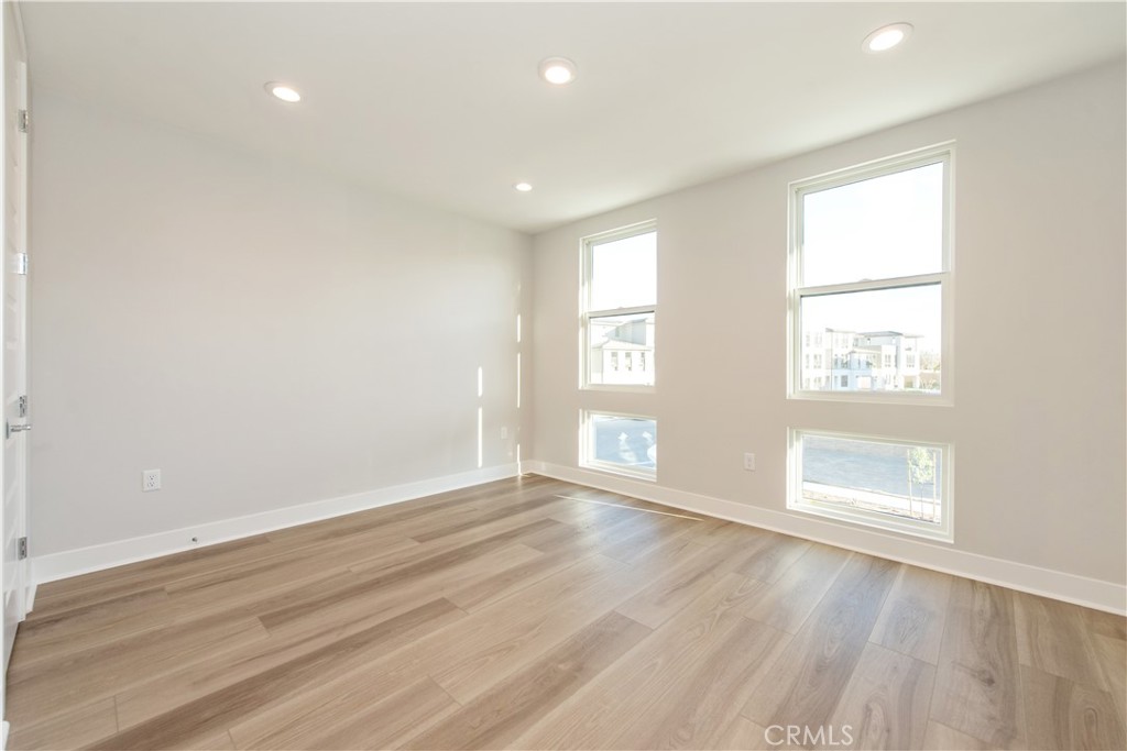 209 Mask Irvine, CA 92618 - Photo 17 of 40 an empty room with wooden floor and windows