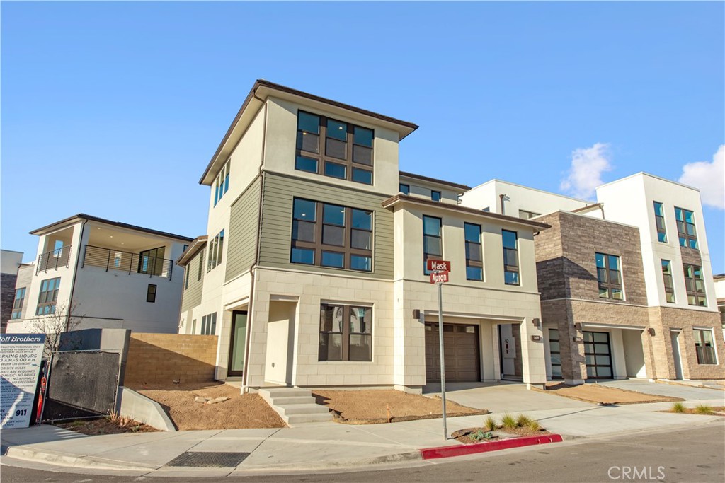 209 Mask Irvine, CA 92618 - Photo 2 of 40 a front view of a building with lot of cars and trees