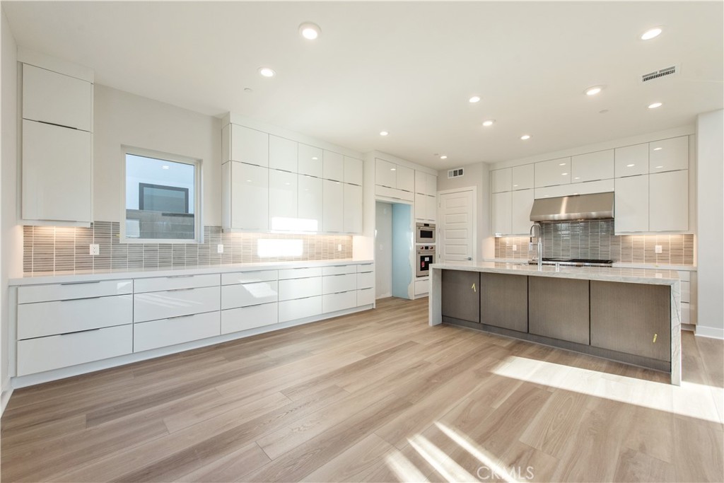209 Mask Irvine, CA 92618 - Photo 6 of 40 a large kitchen with kitchen island a sink stainless steel appliances and cabinets