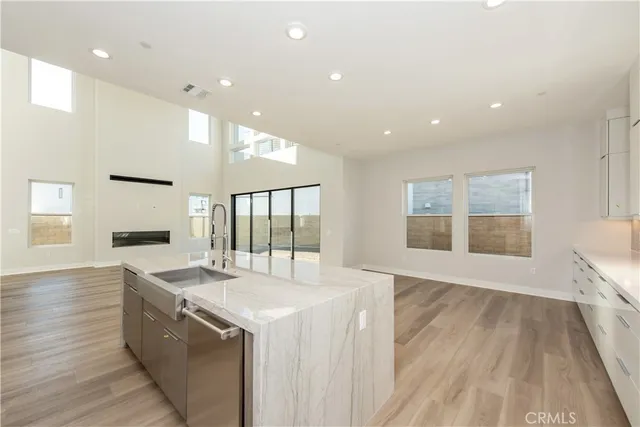 a large kitchen with granite countertop a large counter top and sink