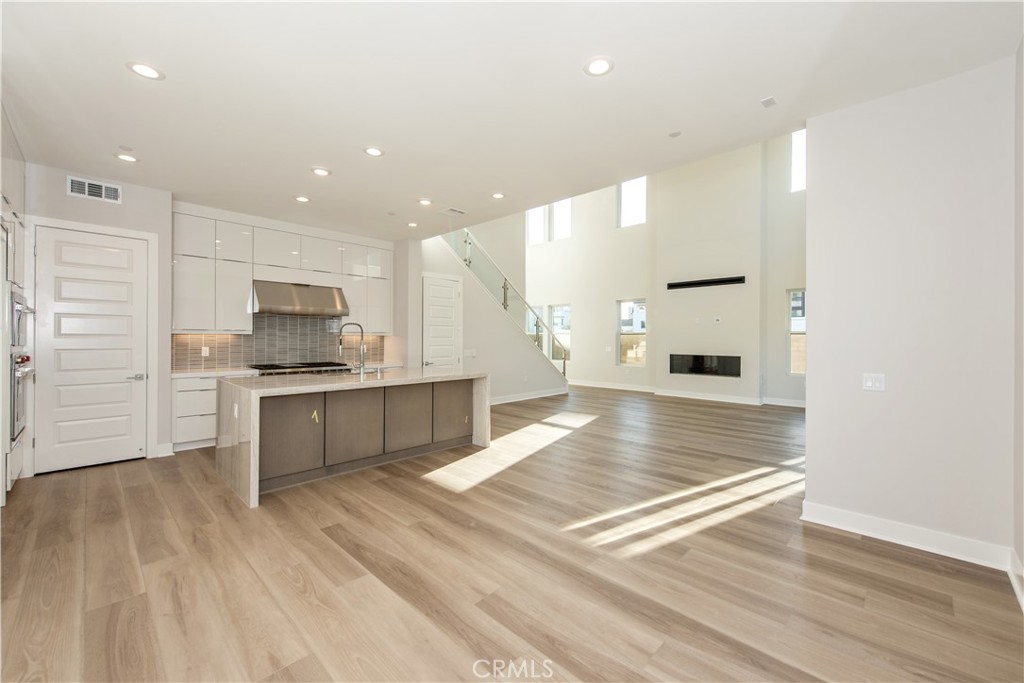 209 Mask Irvine, CA 92618 - Photo 8 of 40 a large kitchen with kitchen island a sink stainless steel appliances and cabinets