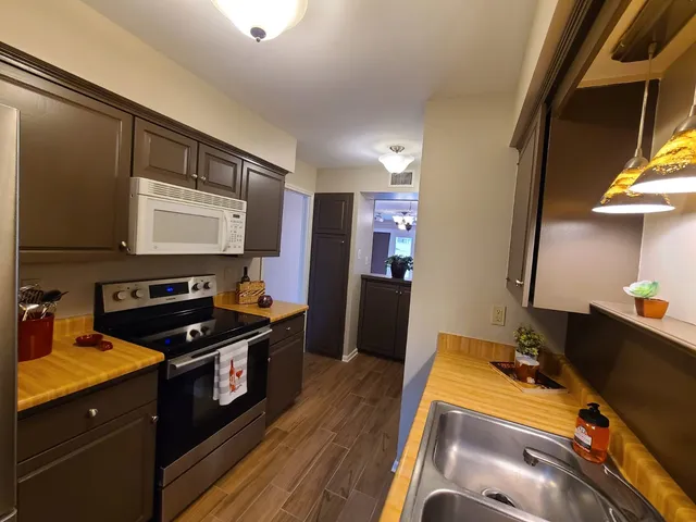 a kitchen with a sink appliances and cabinets