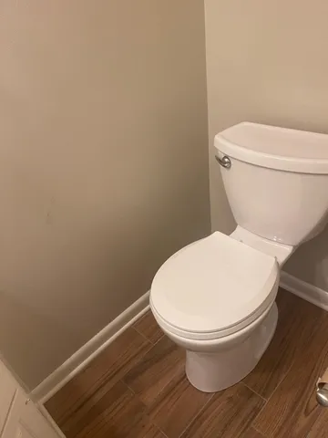 a bathroom with a sink and mirror with toilet