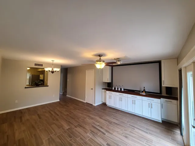a kitchen with granite countertop a sink and a stove top oven
